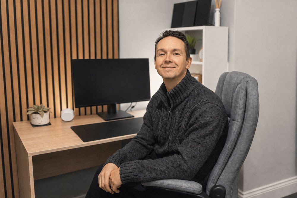 Gareth Thomas, hypnotherapist in Pembrokeshire, seated in his consultation room.